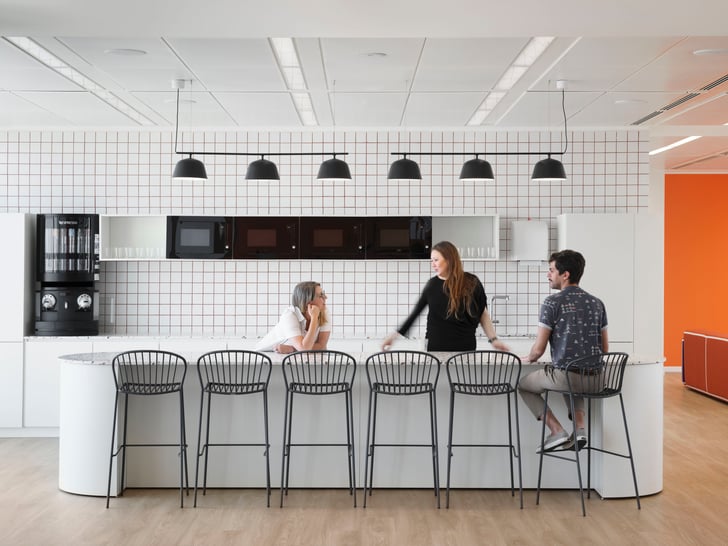 workers chatting in the office kitchen