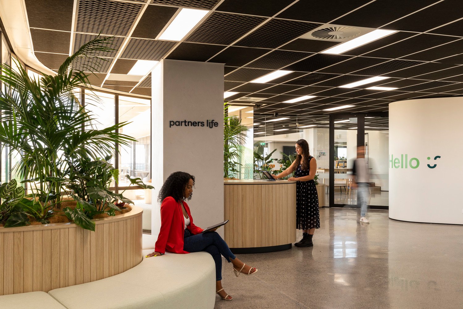 Reception and seating area in Partners Life office with logo 