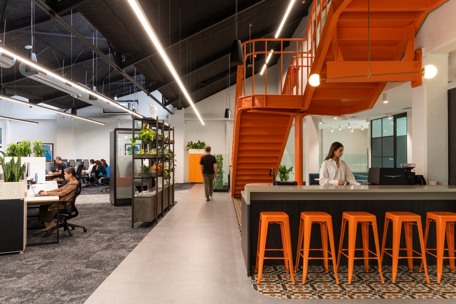 View of staff kitchen, mezzanine and open-plan employee work area 