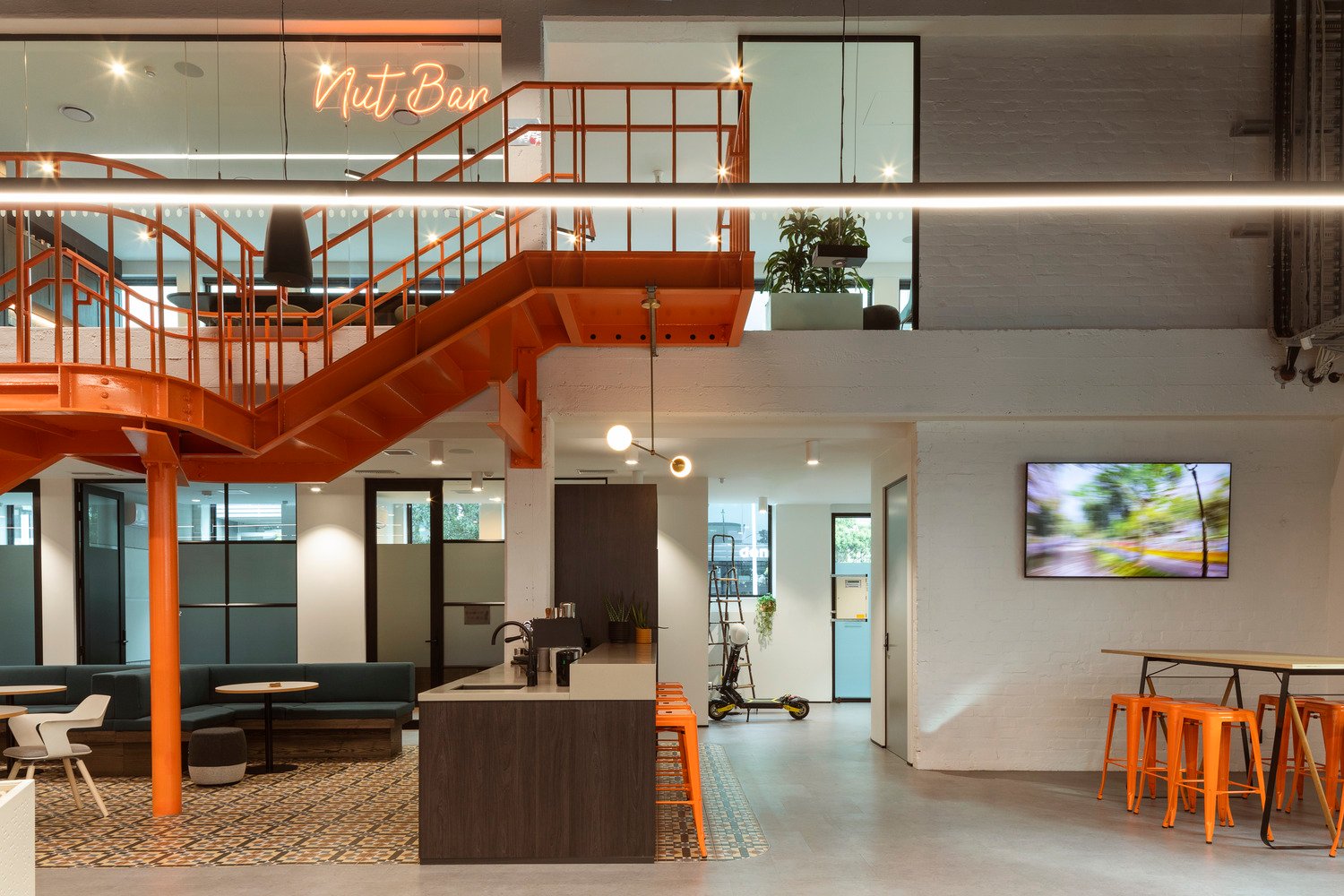 Orange internal staircase connects the ground-floor to mezzanine floor