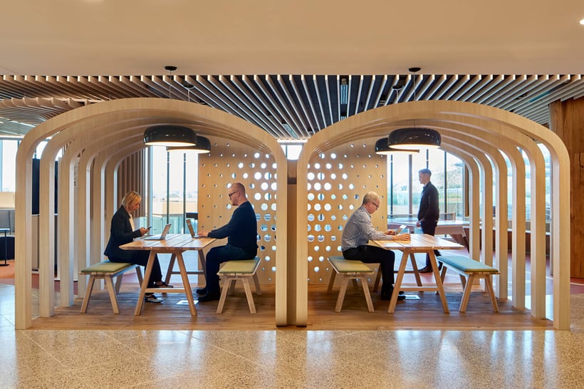 employees sitting in small huddle rooms