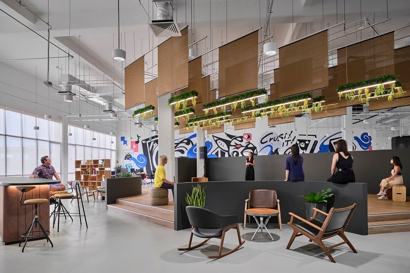 Workplace office fit out with people congregating in common area.