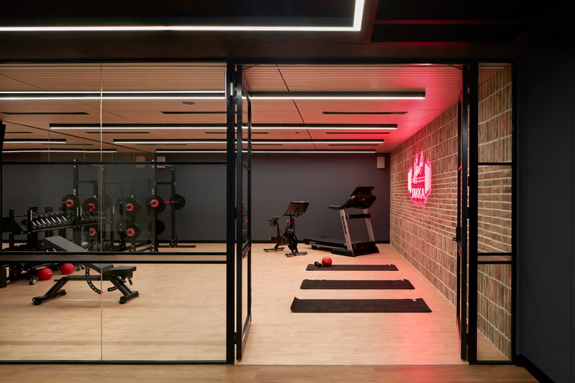 Global software company gym/wellness space with neon sign