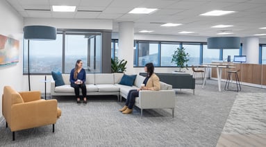 Employees sitting on couches talking