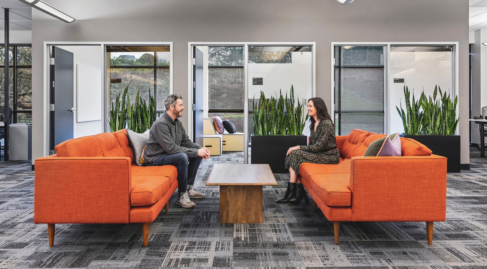 two employees sitting on couches in the workplace