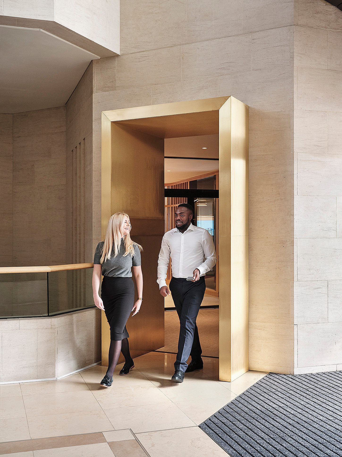 Two employees walking through doorway