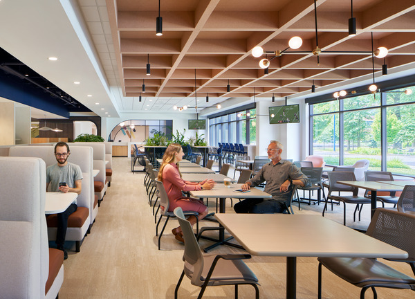 employees sitting and chatting in an office cafe