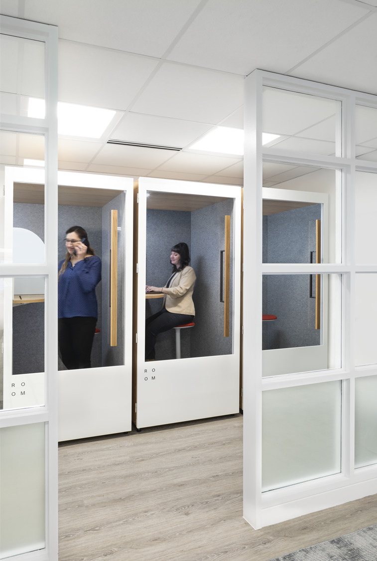 Coworkers using phone booths