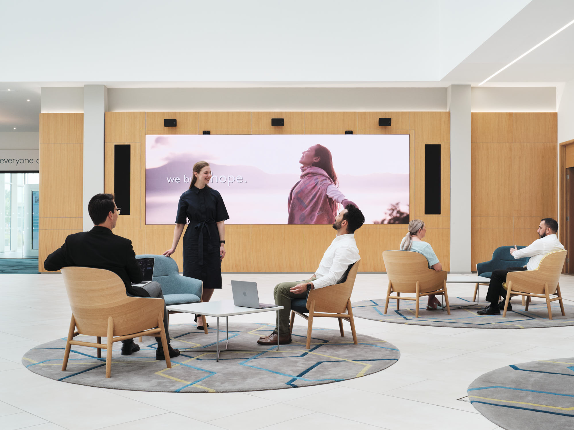 employees talking to each other in open meeting space