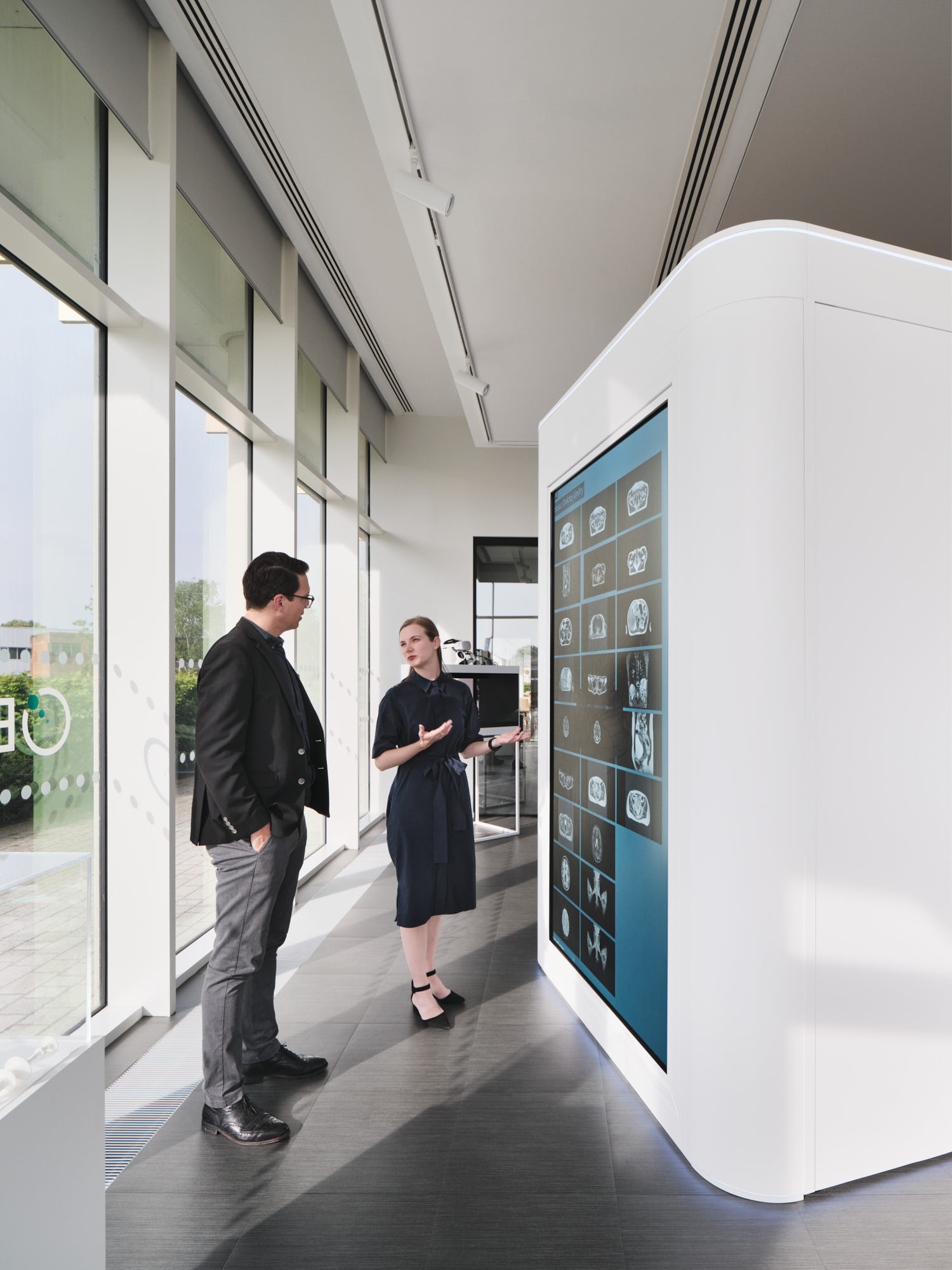 employee talking to colleague and pointing at screen