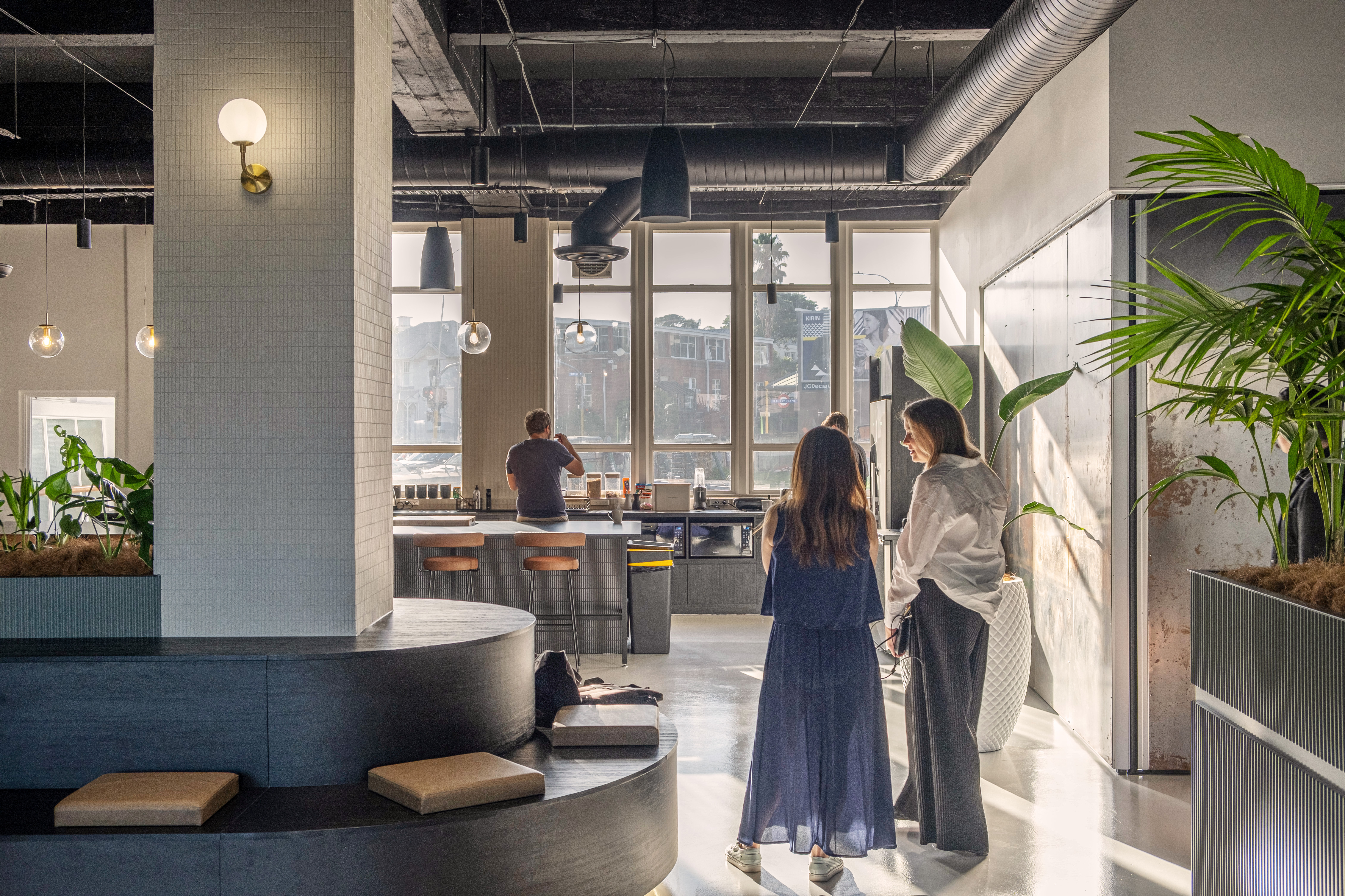 Sunlight streaming into kitchen with people talking