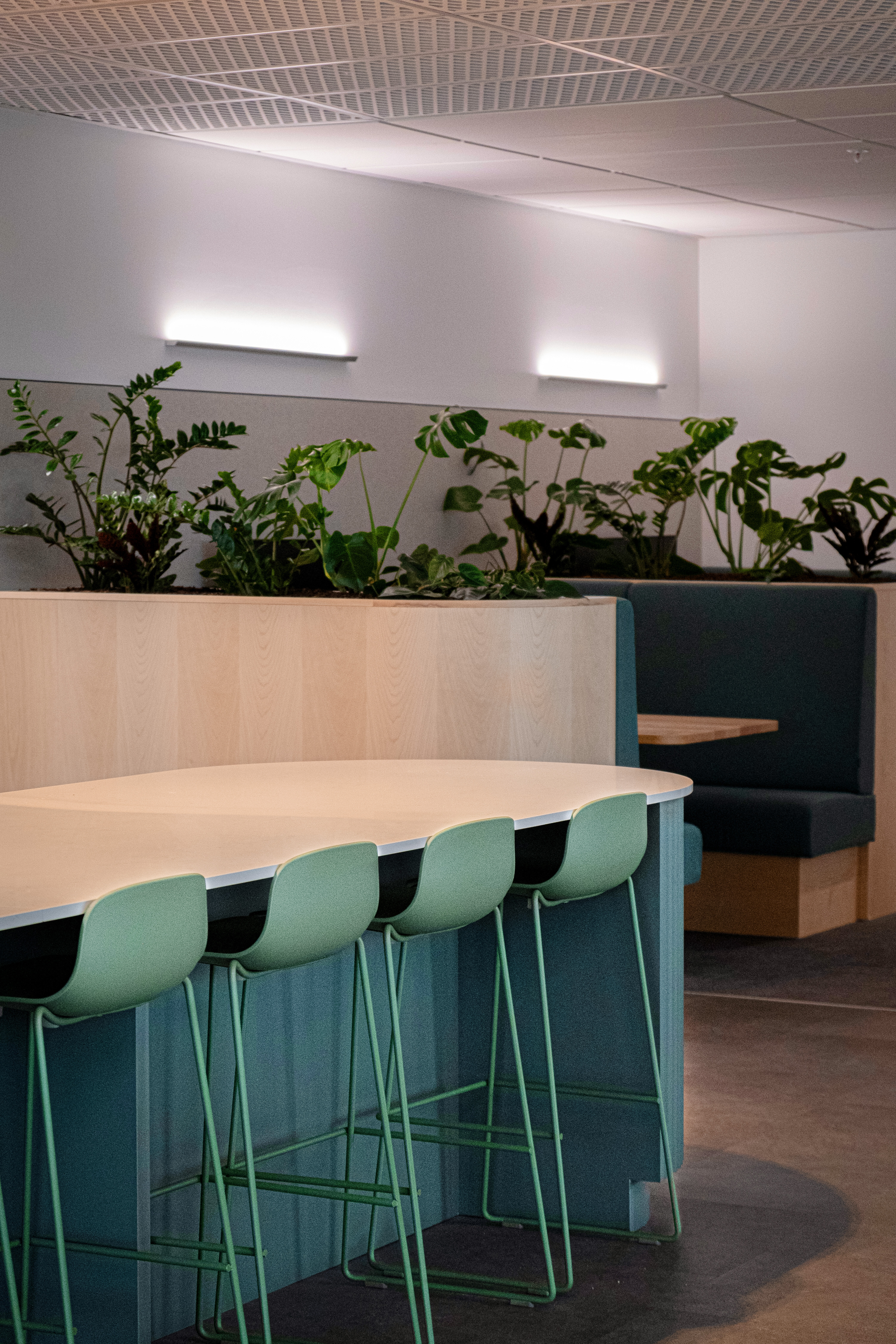 kitchen island bench seating with collaboration booth in the background