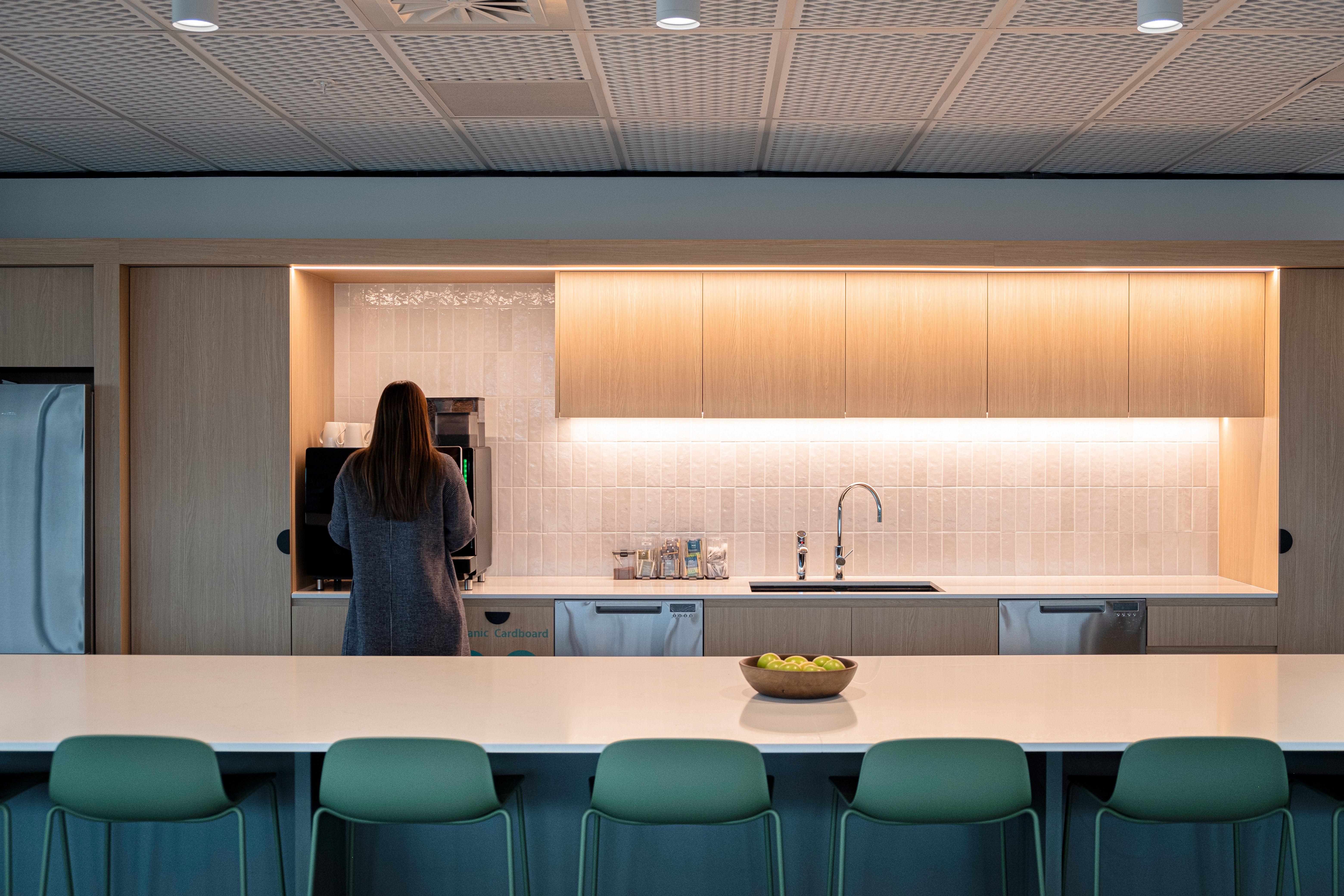 Kitchen in Rabobank's office with timber and green tones