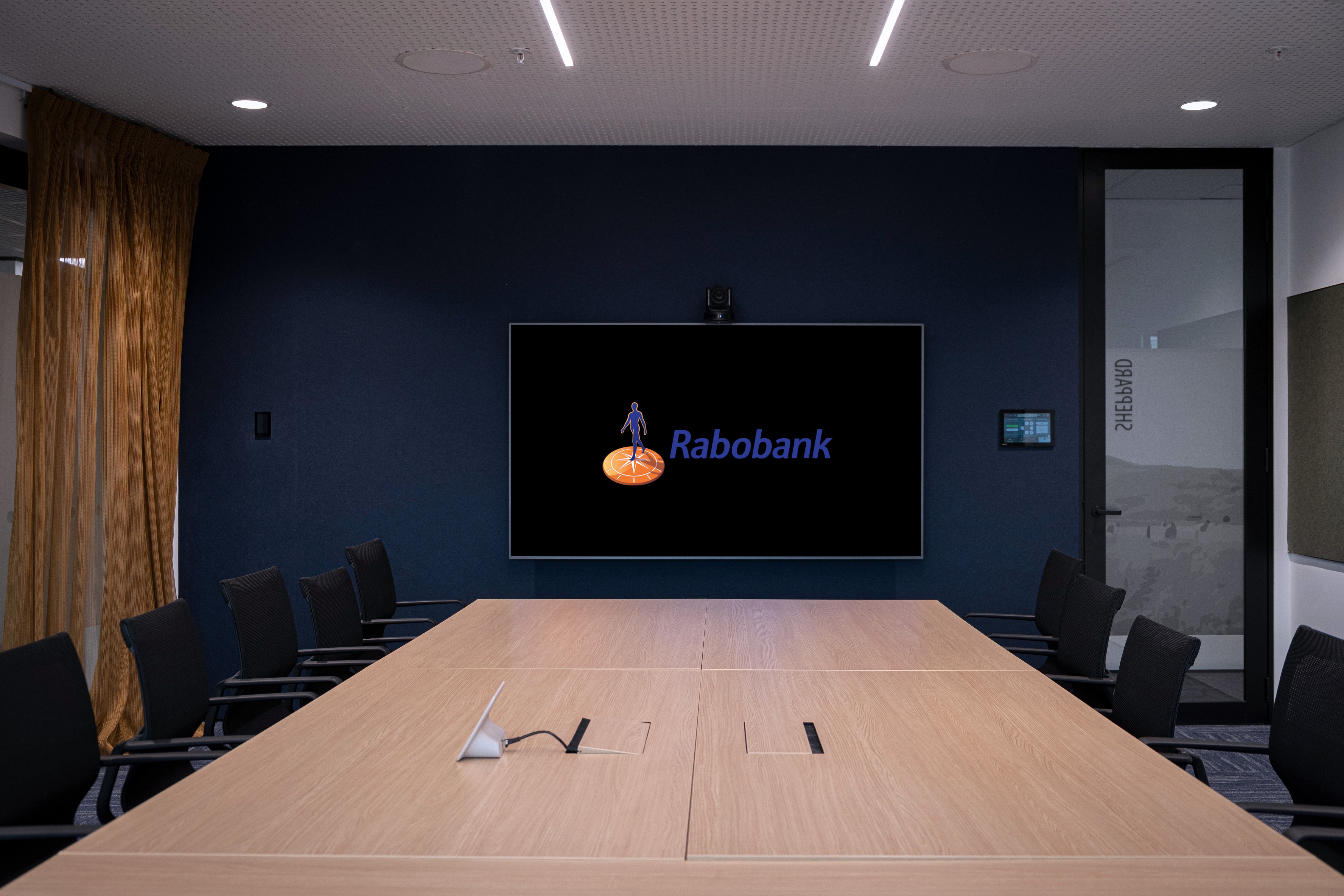 Boardroom meeting space with screen and seating