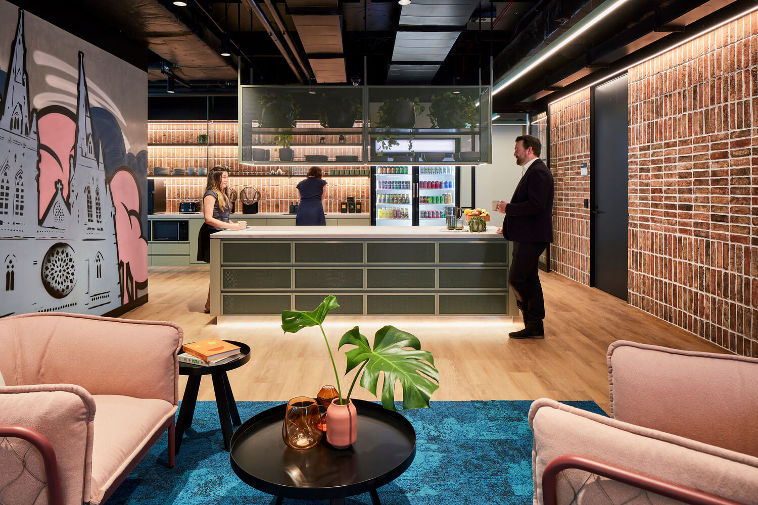 Open kitchen and welcome space with exposed brick Global software company Sydney