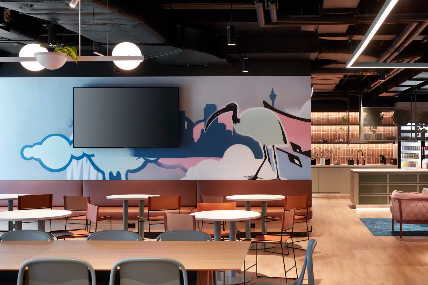 Breakout space with ibis graphic mural Global software company Sydney