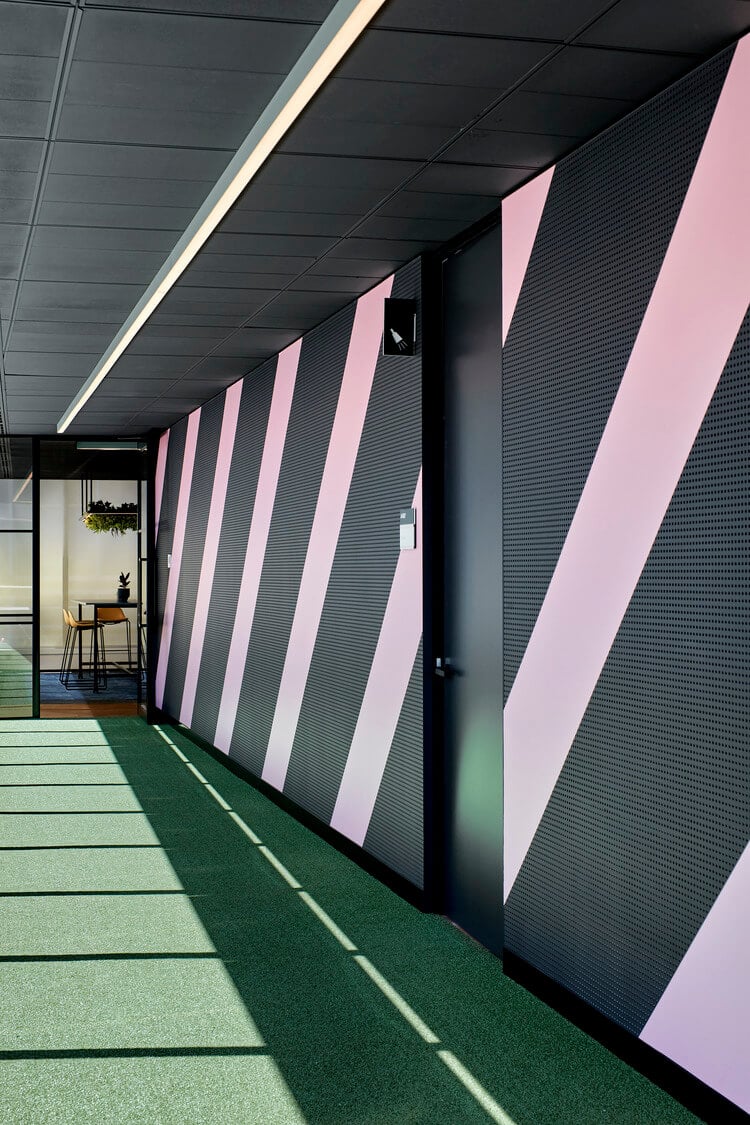 Striped pink wall office games space Global software company