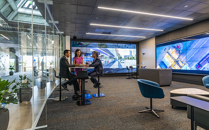 Small group in an enclosed room with large screen walls