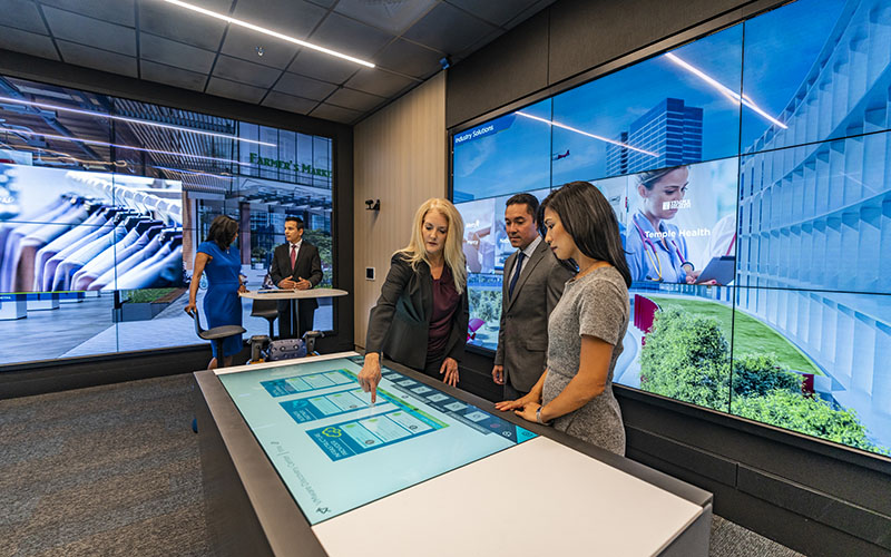 Group of people interacting with touchscreen tabletop
